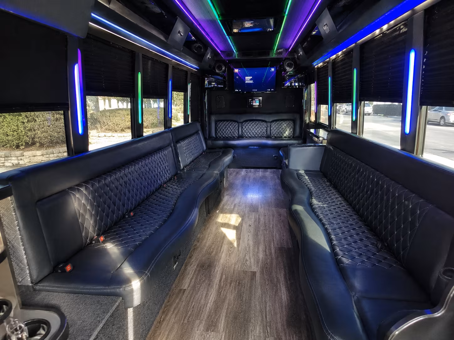 Friends laughing during a party bus celebration in Grand Prairie