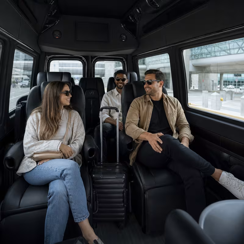 Passengers loading luggage while boarding an Grand Prairie group shuttle