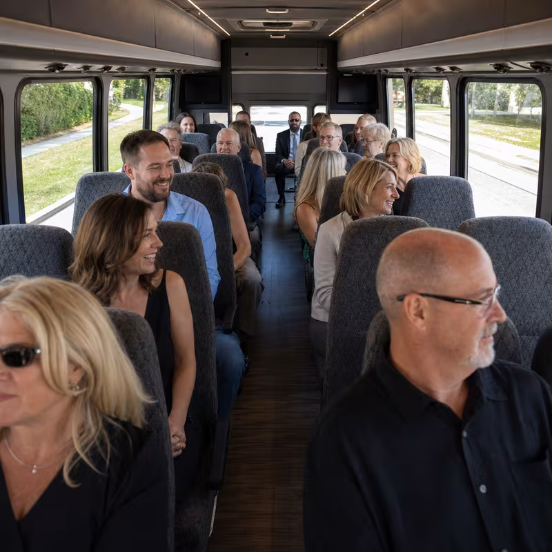 Group boarding a white charter bus for Private Event Transportation transportation in Grand Prairie