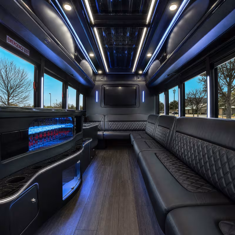 Party bus interior with wraparound leather seating and LED lighting in Grand Prairie