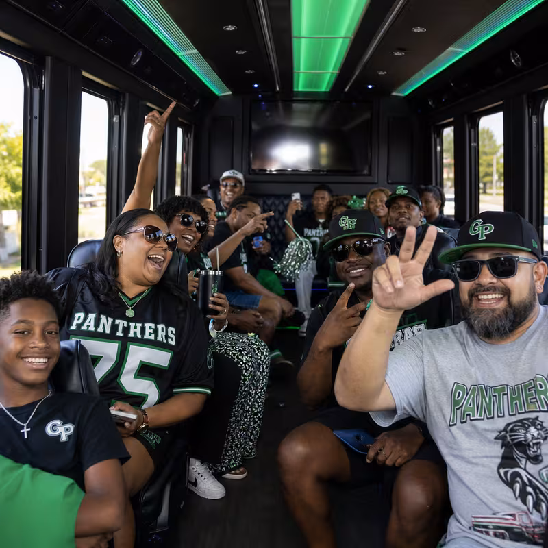 Group boarding a white charter bus for Sporting Event Transportation transportation in Grand Prairie